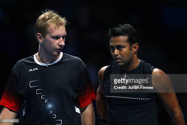 Lukas Dlouhy of Czech Republic talks to Leander Paes of India during the men's doubles first round match against Lukasz Kubot of Poland and Oliver...