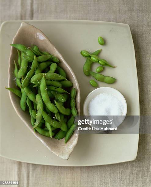 steamed edamame with dish of salt - soy dressing stock pictures, royalty-free photos & images