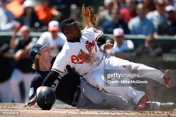 Chance Adams of the New York Yankees tags out Tim Beckham of the Baltimore Orioles during the second inning of the Spring Training game against the...