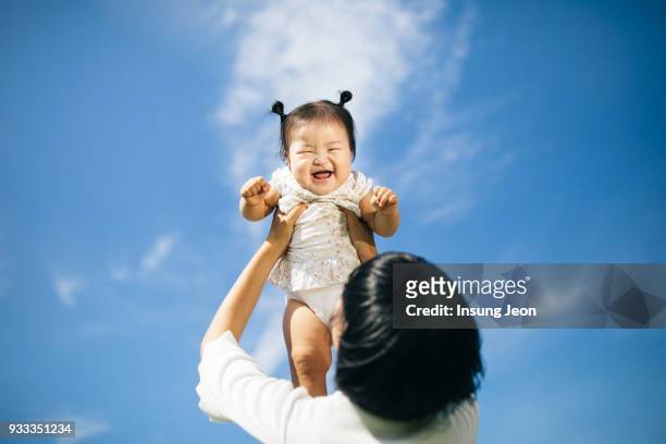 happy mother having fun with her baby - kor stock pictures, royalty-free photos & images