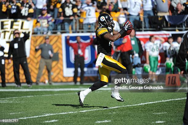 Wide receiver Mike Wallace of the Pittsburgh Steelers runs with the football after catching a pass during a game against the Minnesota Vikings at...