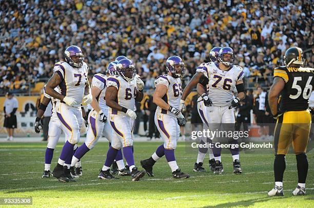 Offensive linemen Phil Loadholt, Anthony Herrera, John Sullivan, Steve Hutchinson and Bryant McKinnie of the Minnesota Vikings walk to the line of...