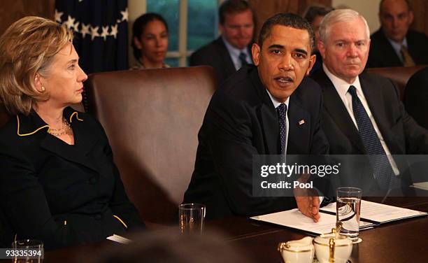 Secretary of State Hillary Rodham Clinton and Secretary of Defense Robert Gates listen as U.S. President Barack Obama speaks at a cabinet meeting as...