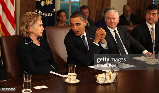 Secretary of State Hillary Rodham Clinton listens along with Secretary of Commerce Gary Locke and Secretary of Defense Robert Gates as U.S. President...