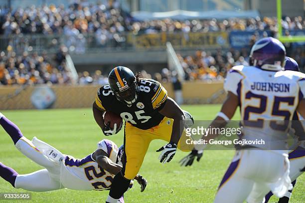 Tight end David Johnson of the Pittsburgh Steelers runs with the football after catching a pass against cornerback Benny Sapp of the Minnesota...