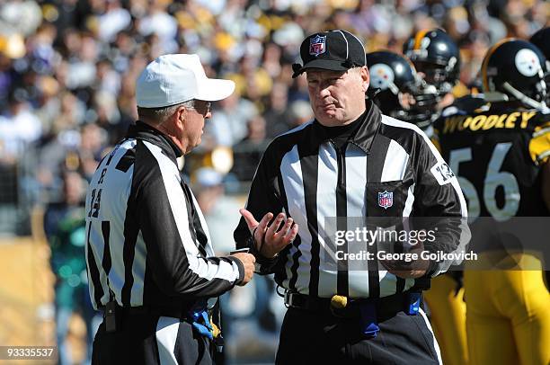 National Football League officials, referee Ron Winter and umpire Bill Schuster, confer during a game between the Minnesota Vikings and Pittsburgh...