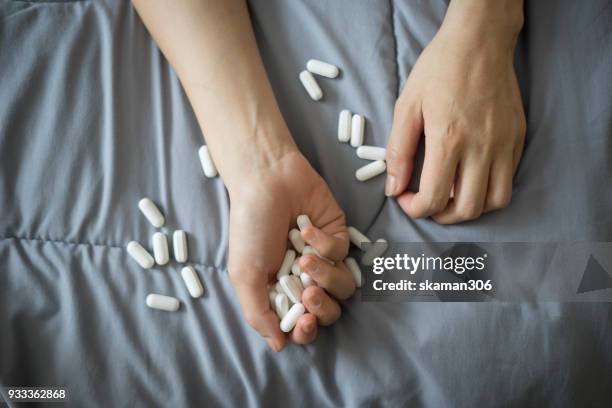 female suicide with medicine tablet - zelfmoord stockfoto's en -beelden