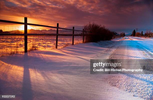 sunrise snow road - bill hinton stockfoto's en -beelden