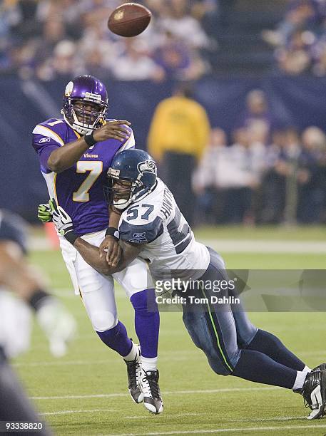 Tarvaris Jackson of the Minnesota Vikings passes the ball while under pressure from David Hawthorne of the Seattle Seahawks during an NFL game at the...