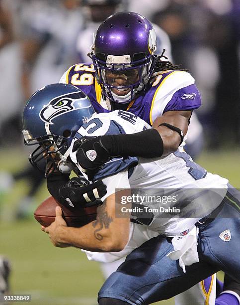 Husain Abdullah of the Minnesota Vikings tackles Seneca Wallace of the Seattle Seahawkss during an NFL game at the Mall of America Field at Hubert H....