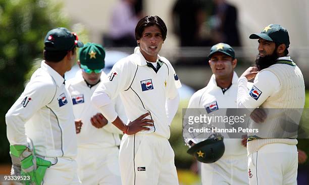 Mohammad Aamer of Pakistan looks on with his team during day one of the First Test match between New Zealand and Pakistan at University Oval on...