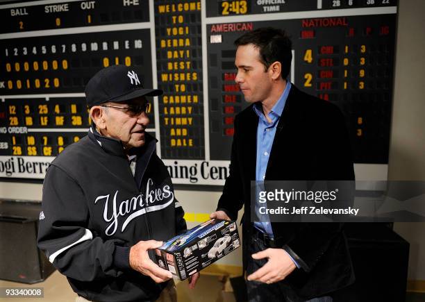 Four-time Nascar champion Jimmie Johnson presents a model of his Lowe's Chevrolet to Baseball Hall of Famer Yogi Berra at a tour of the Yogi Berra...