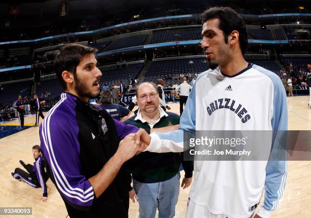 First Iranian NBA player Hamed Haddadi of the Memphis Grizzlies shakes hands pregame with first Israeli NBA player Omri Casspi the Sacramento Kings...