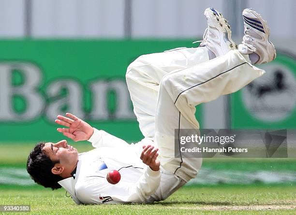 Saeed Ajmal of Pakistan fields off his own bowling during day one of the First Test match between New Zealand and Pakistan at University Oval on...