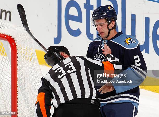 Keith Ballard of the Florida Panthers has his mouth checked by referee Kevin Pollock after he was hit by Sidney Crosby of the Pittsburgh Penguins on...