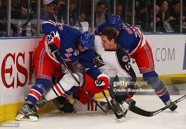 Mike Blunden of the Columbus Blue Jackets is dumped by Donald Brashear of the New York Rangers at Madison Square Garden on November 23, 2009 in New...