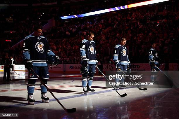 Keith Ballard, Nathan Horton, Stephen Weiss, and Jordan Leopold stand on the ice for the National Anthem prior to the start of the game against the...