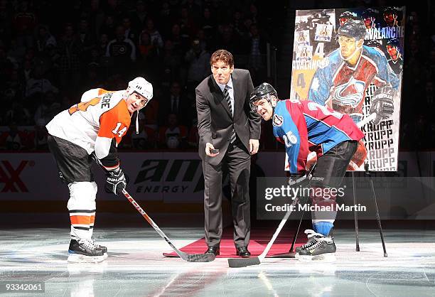 Former Avalanche player Uwe Krupp drops the puck as Ian Laperriere the Philadelphia Flyers and Paul Stastny of the Colorado Avalanche face off during...