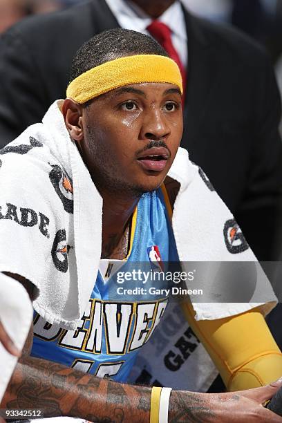 Carmelo Anthony of the Denver Nuggets takes a rest on the bench during the game against the Milwaukee Bucks at the Bradley Center in Milwaukee,...