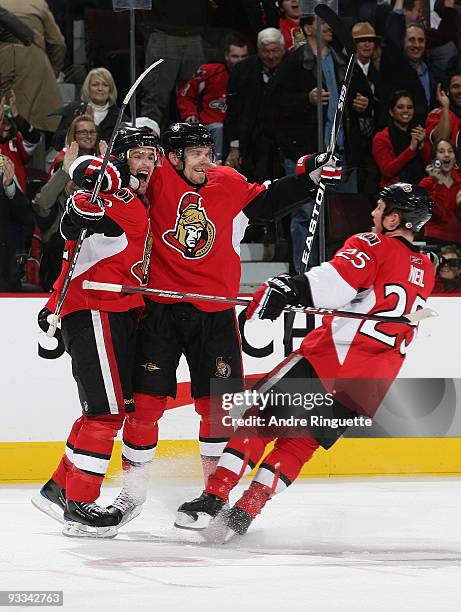 Mike Fisher of the Ottawa Senators celebrates his overtime game winning goal against the Washington Capitals with team mates Milan Michalek and Chris...