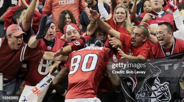 Wide receiver Andre Johnson of the Houston Texans jumps into the crowd after scoring a touchdown in the second quarter against the Tennessee Titans...