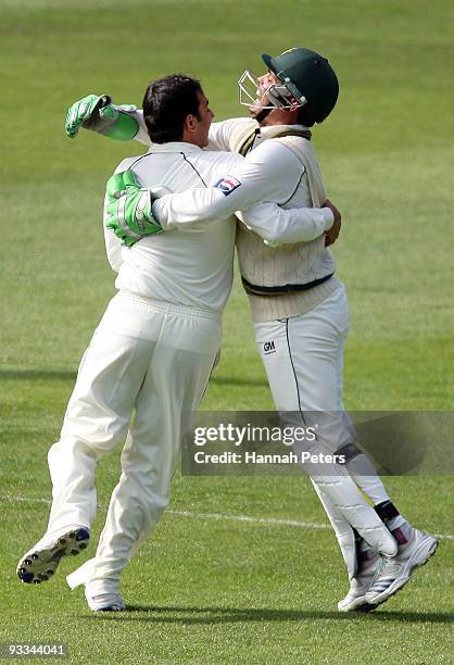 Saeed Ajmal celebrates with Kamran Akmal of Pakistan after dismissing Ross Taylor of New Zealand for 94 runs during day one of the First Test match...