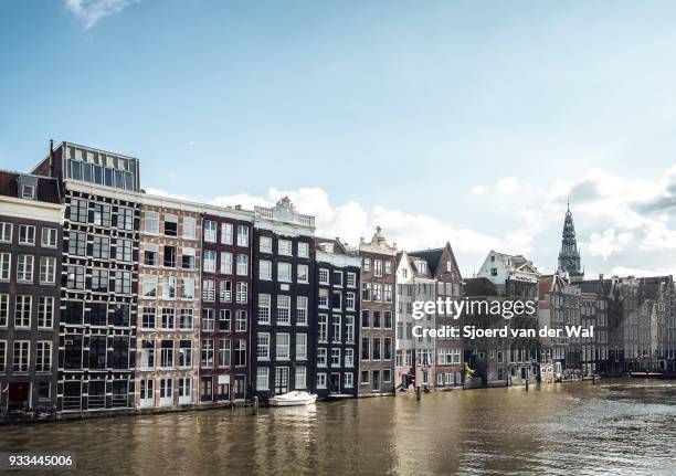 traditional old buildings at a canal in amsterdam, the netherlands - sjoerd van der wal stock pictures, royalty-free photos & images