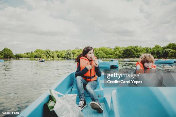 tourist kids on pedal boat in london - pedal boat stock pictures, royalty-free photos & images