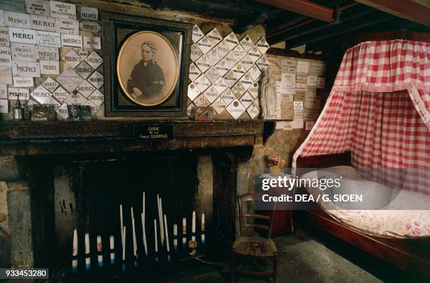 Bedroom of Bernadette Soubirous, with ex-voto, Moulin Lacade, Saint Bernadette Soubirous father's home, Lourdes, Languedoc-Roussillon-Midi-Pyrenees,...