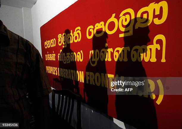 The shadow of Sri Lanka's main leftist party spokesman and lawmaker Anurakumara Dissanayake is cast on party signage after the announcement of former...