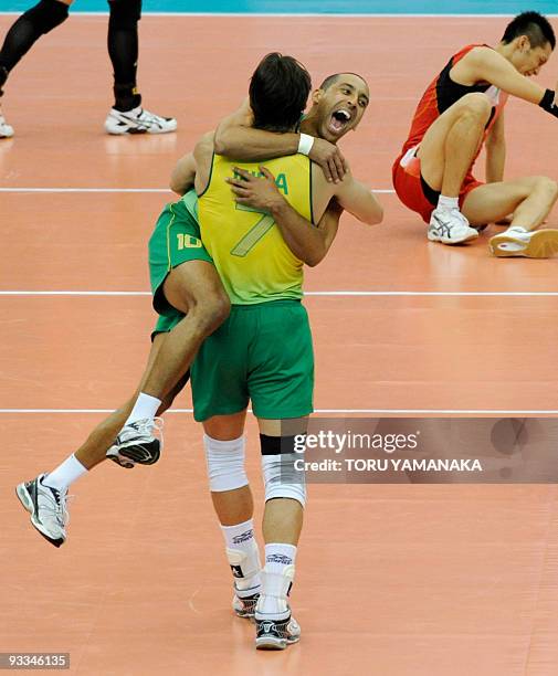 Brazilian captain Gilberto Godoy Filho hugs teammate Sergio Dutra Santos as they celebrate their victory over Japan in the final match of the men's...