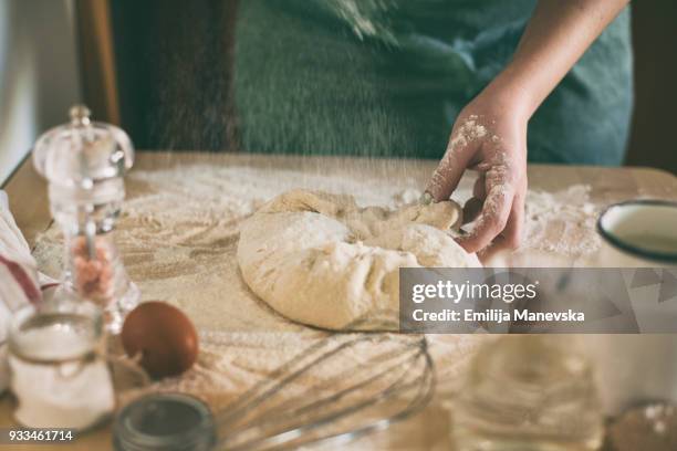 young woman kneading dough in kitchen - teig kneten stock-fotos und bilder