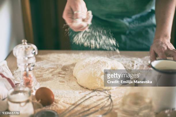 young woman kneading dough in kitchen - chopping block flour stock pictures, royalty-free photos & images