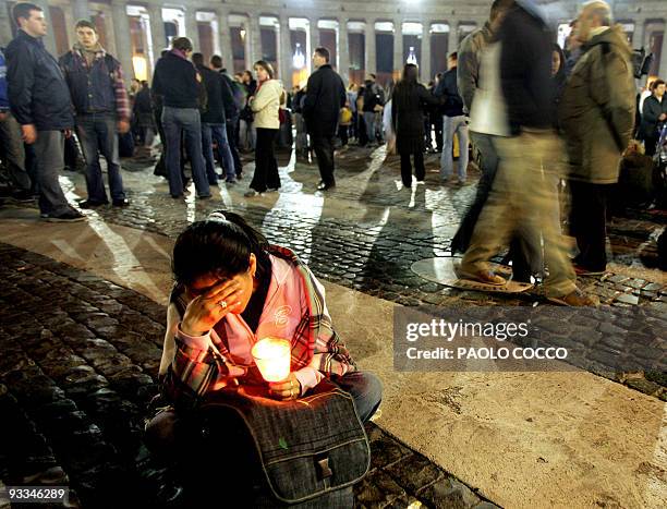 Woman prays at St. Peter's Square in the Vatican City, 02 April 2005, after the death of Pope John Paul II. "The Holy Father died this evening at...