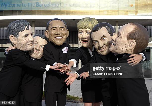 Members of anty-poverty group Oxfam wearing masks of world leaders British Prime Minister Gordon Brown, French President Nicolas Sarkozy, US...