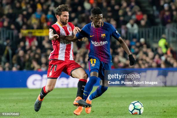 Ousmane Dembele of FC Barcelona fights for the ball with Carles Planas Antolinez of Girona FC during the La Liga 2017-18 match between FC Barcelona...