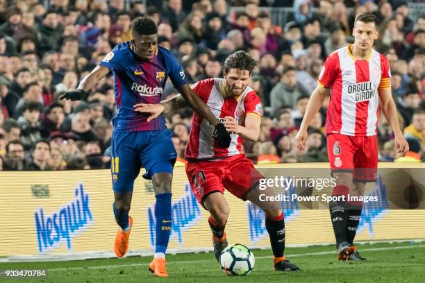 Ousmane Dembele of FC Barcelona fights for the ball with Carles Planas Antolinez of Girona FC during the La Liga 2017-18 match between FC Barcelona...