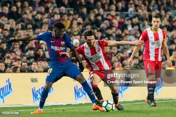 Ousmane Dembele of FC Barcelona fights for the ball with Carles Planas Antolinez of Girona FC during the La Liga 2017-18 match between FC Barcelona...