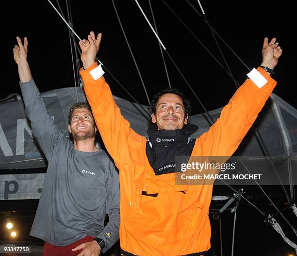 French yachtmen Marc Guillemot and Charles Caudrelier , skippers of the monohull "Safran", wave on November 24, 2009 in Puerto Limon harbour after...