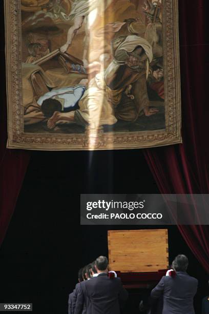 The coffin carrying the body of Pope John Paul II is taken inside St Peter's Basilica at the Vatican City 08 April 2005 after the funeral mass. The...