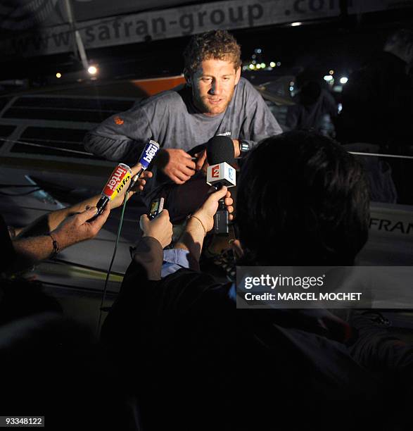 French yachtman Charles Caudrelier speaks to the press aboard the monohull "Safran" on November 24, 2009 in Puerto Limon harbour, after winning with...