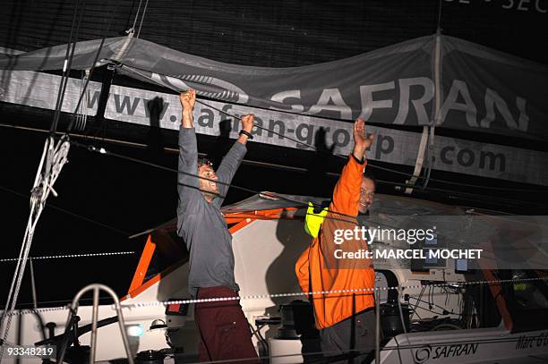 French yachtmen Marc Guillemot and Charles Caudrelier, skippers of the monohull "Safran", jubilate on November 24, 2009 in Puerto Limon harbour after...