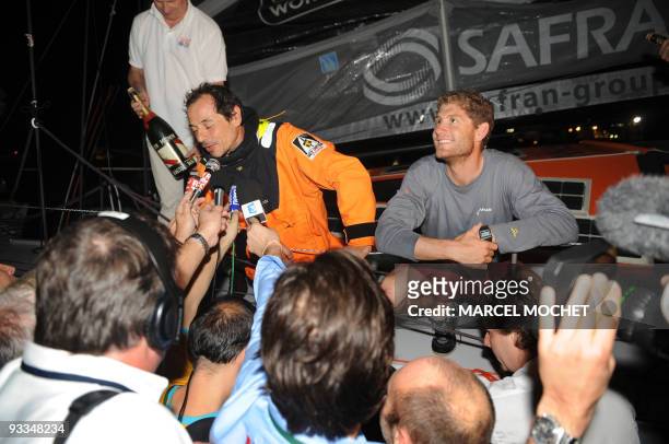 French skippers Marc Guillemot and Charles Caudrelier speak to the press aboard their monohull "Safran" on November 24, 2009 in Puerto Limon harbour,...