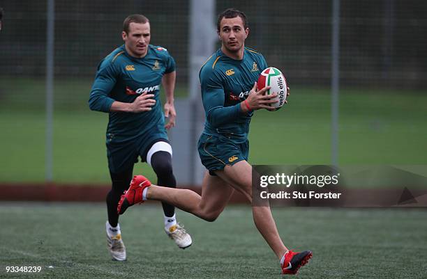 Matt Giteau of Australia looks on as Quade Cooper prepares to pass during the Australia Wallabies training at the Treforest University Grounds on...