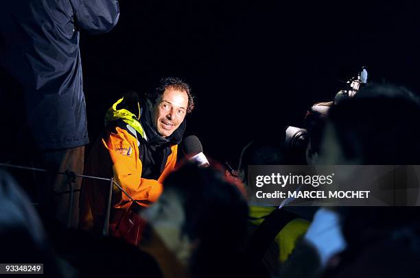 French yachtman Marc Guillemot speaks to the press aboard the monohull "Safran" on November 24, 2009 in Puerto Limon harbour, after winning with...