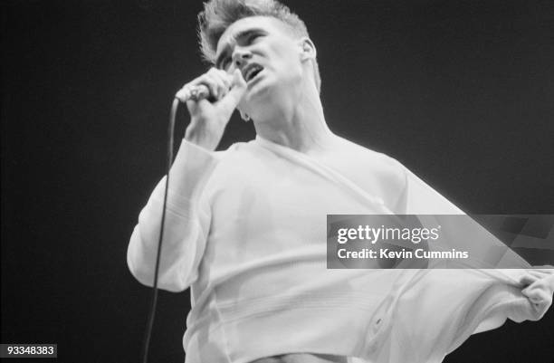 Singer Morrissey performing with English pop group The Smiths at the GMEX centre, Manchester , at the Festival Of The 10th Summer, during their 'The...