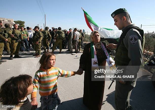 Palestinians demonstrate near Israeli forces against the Jewish state's controversial separation barrier in the West Bank village of Maasarah, near...