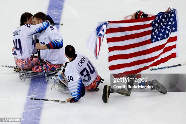 Players of the United States celebrates the gold medal after winning in the Ice Hockey gold medal game between United States and Canada during day...