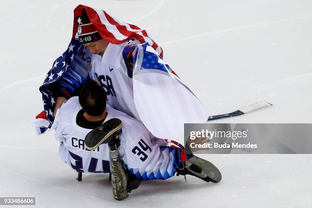 Goalkeepers Steve Cash and Jen Lee of the United States celebrate the gold medal after winning in the Ice Hockey gold medal game between United...