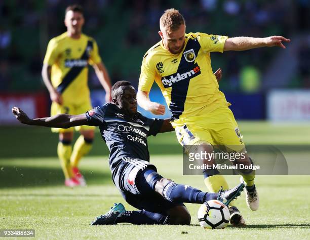 Thomas Deng of the Victory tackles Connor Pain of the Mariners during the round 23 A-League match between the Melbourne Victory and the Central Coast...